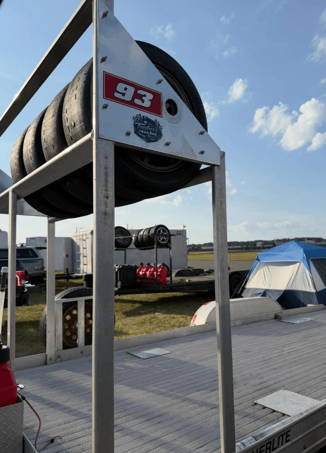 Custom-built overhead aluminum tire rack mounted on a race trailer